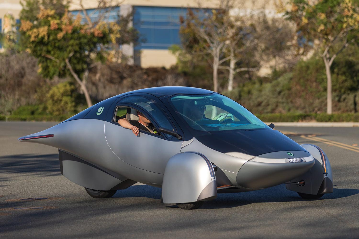 The Aptera Gamma, a three-wheeled electric vehicle with solar panels on the roof