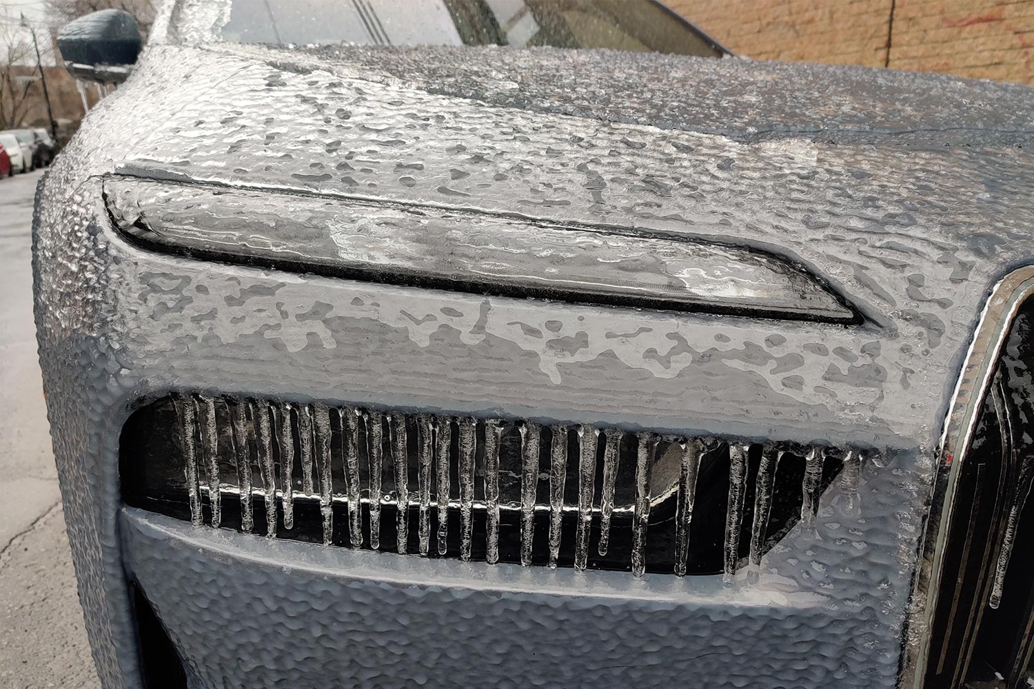 The ice on the front of a BMW i7 EV during our recent review and test