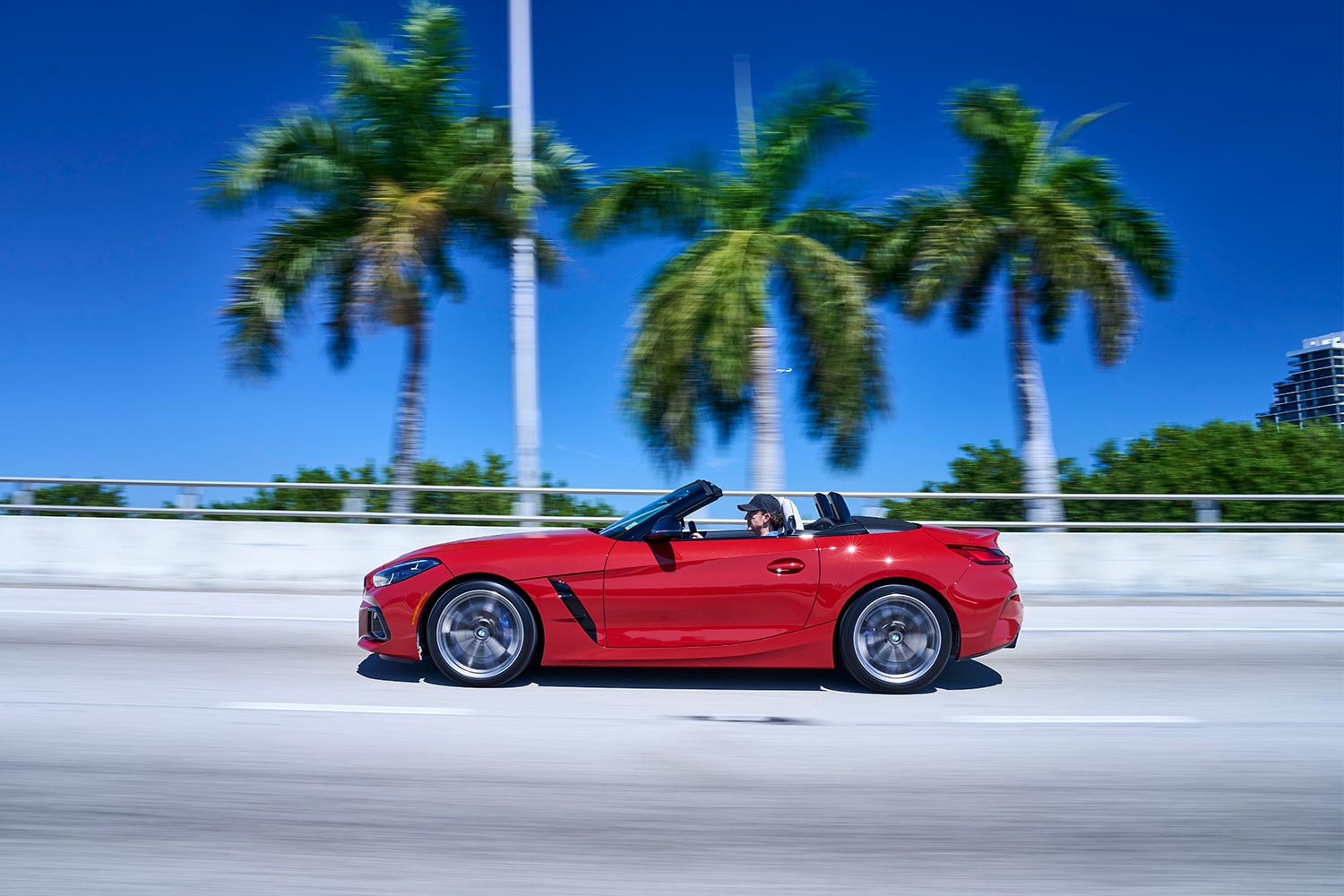 A 2023 BMW Z4 M40i convertible driving next to palm trees