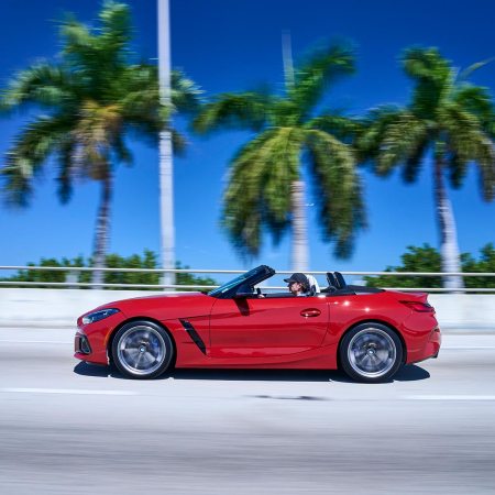 A 2023 BMW Z4 M40i convertible driving next to palm trees