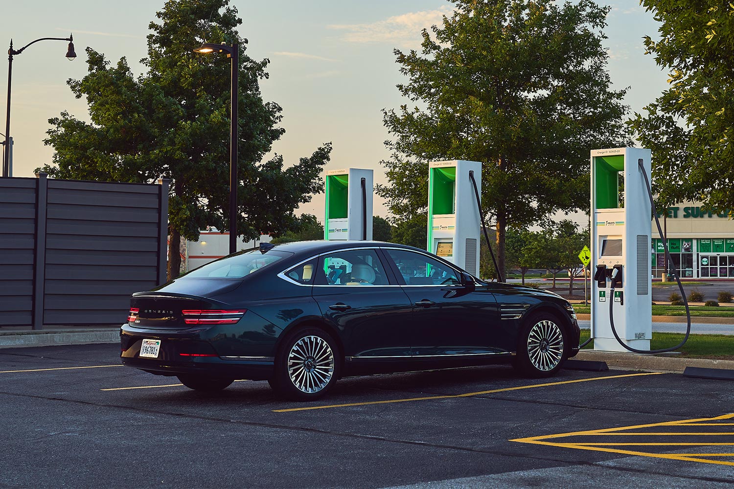 The 2023 Genesis Electrified G80 charging at an EV charge station