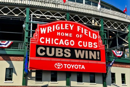 The iconic sign in front of Wrigley Field welcoming visitors to the "Home of the Chicago Cubs" flashes an announcement: "CUBS WIN!"