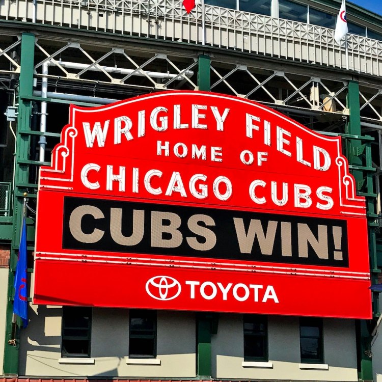 The iconic sign in front of Wrigley Field welcoming visitors to the "Home of the Chicago Cubs" flashes an announcement: "CUBS WIN!"