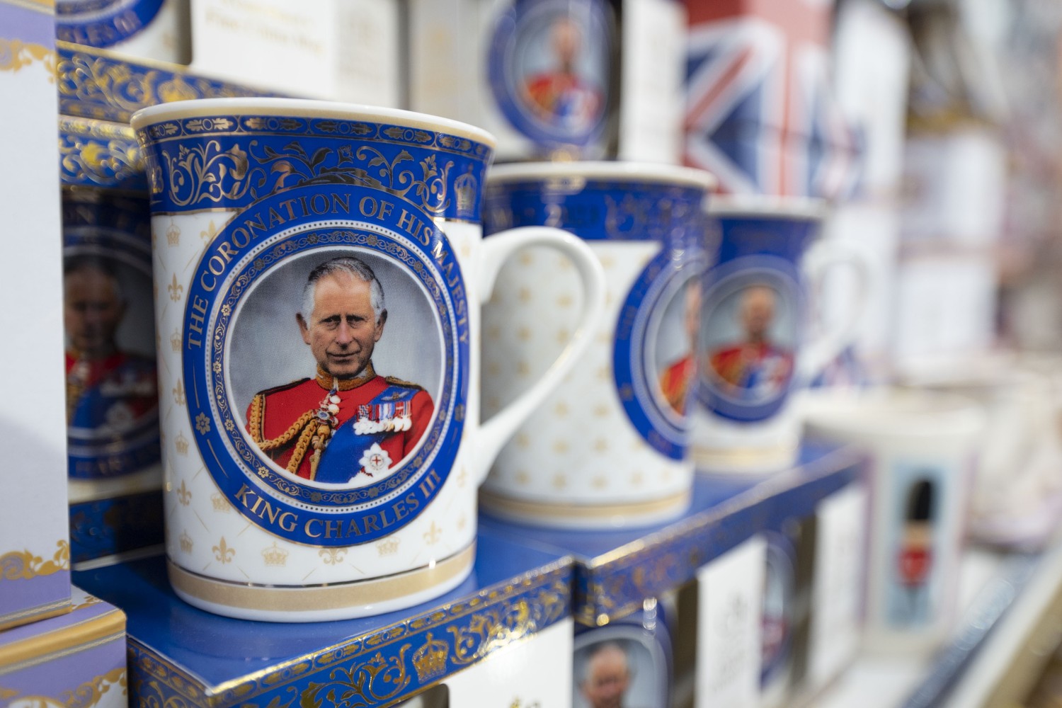 Mugs celebrating the coronation of King Charles III. The Guardian recently released a report that estimates the wealth of the new monarch.