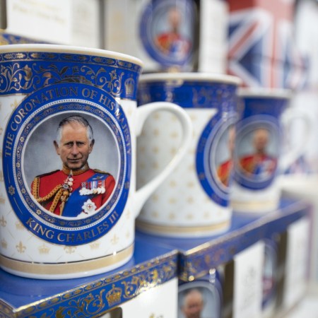 Mugs celebrating the coronation of King Charles III. The Guardian recently released a report that estimates the wealth of the new monarch.