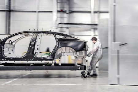 A worker moving an aluminum platform for a Polestar electric vehicle