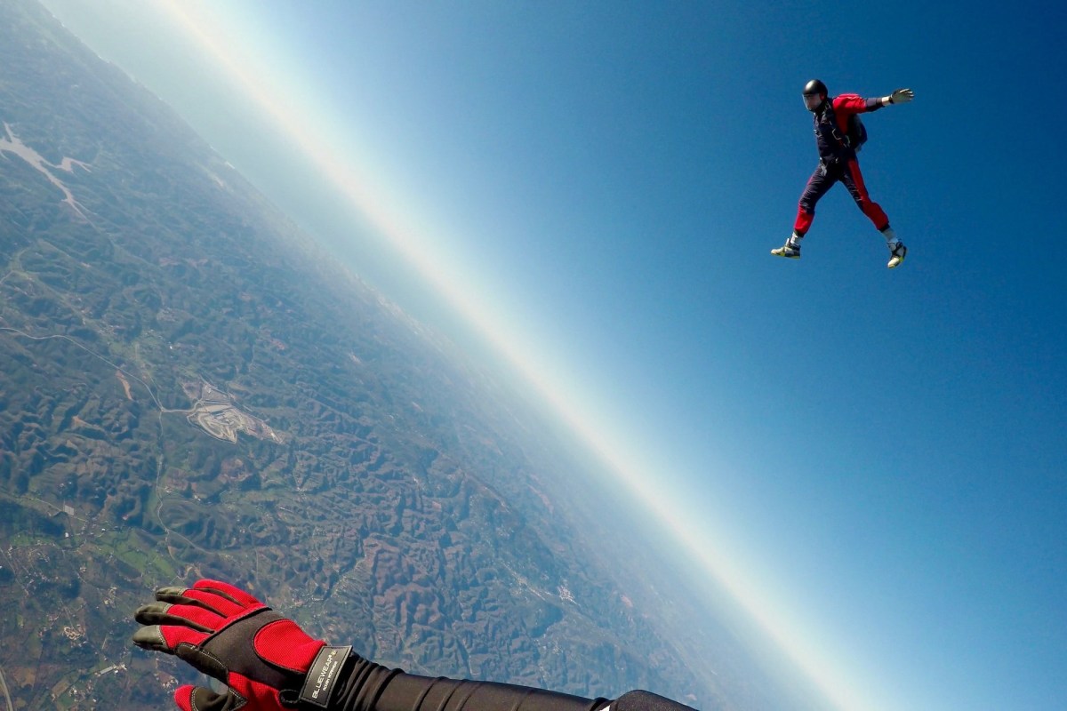 Two people skydiving out of a plane. If this is on your bucket list, maybe reconsider making one at all.