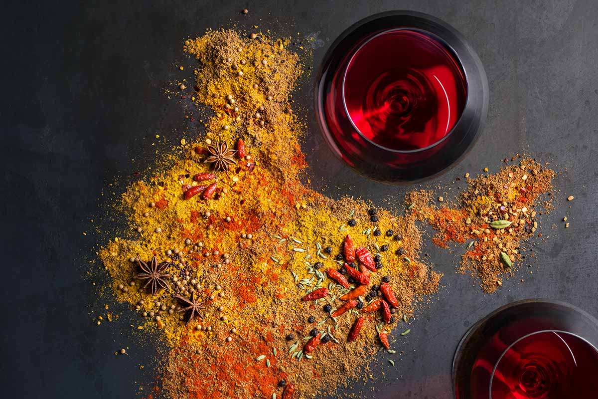 Spices and wineglasses on grey background. Sommelier Beverly Crandon pairs wines with spicy foods.