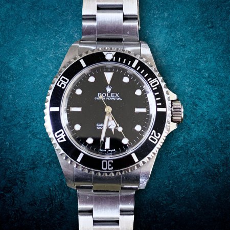 A Rolex Submariner on a blue background