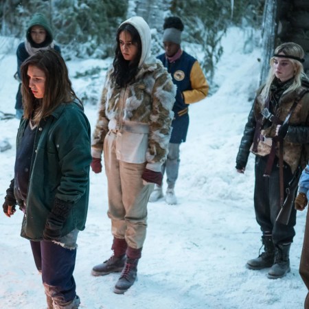 The stranded girls from "Yellowjackets" collect outside the cabin during the snowy months