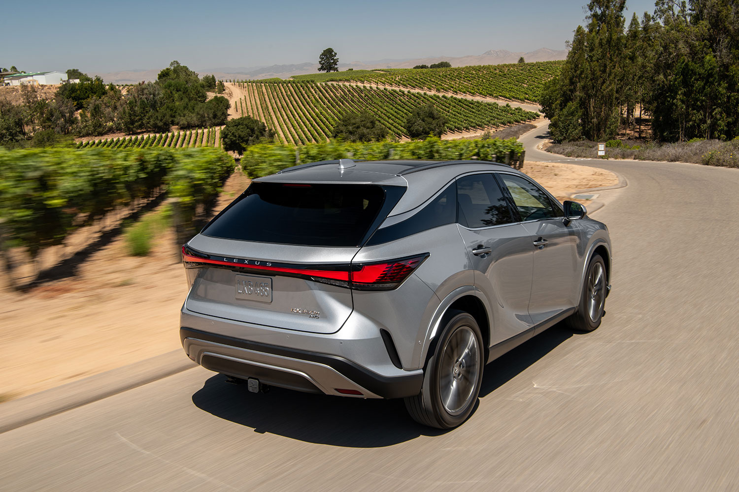 The rear end of the 2023 Lexus RX as it drives away