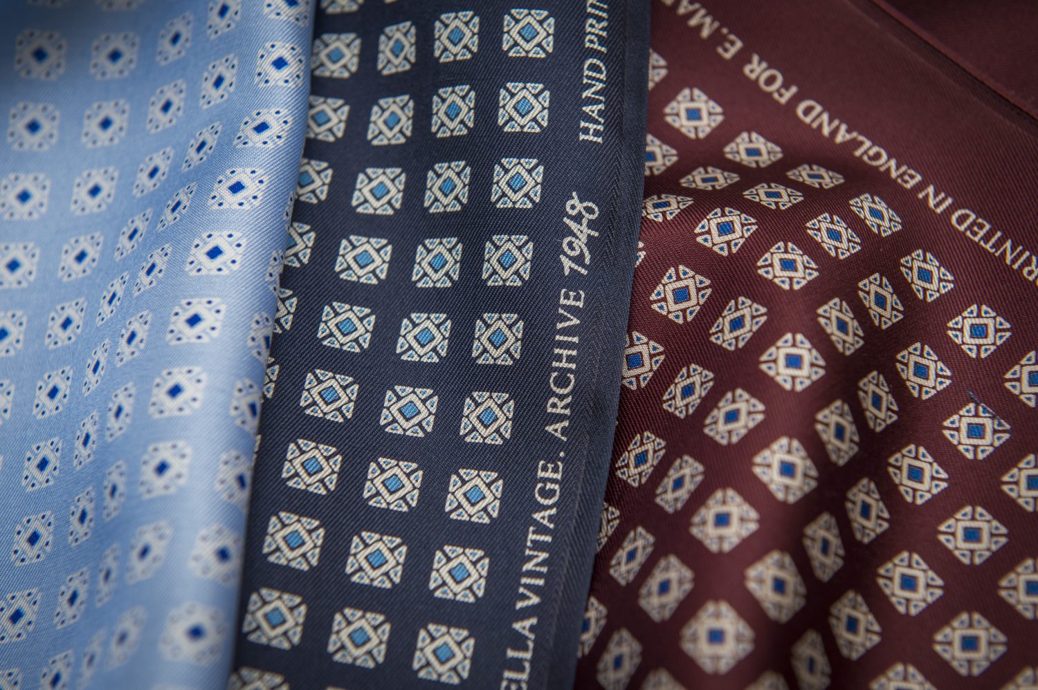 Close-up of light blue, dark blue and red material from a tie.