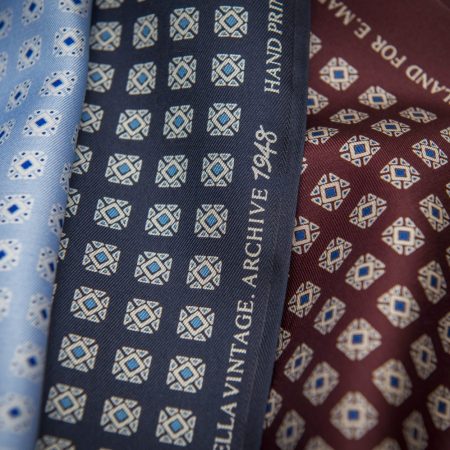 Close-up of light blue, dark blue and red material from a tie.