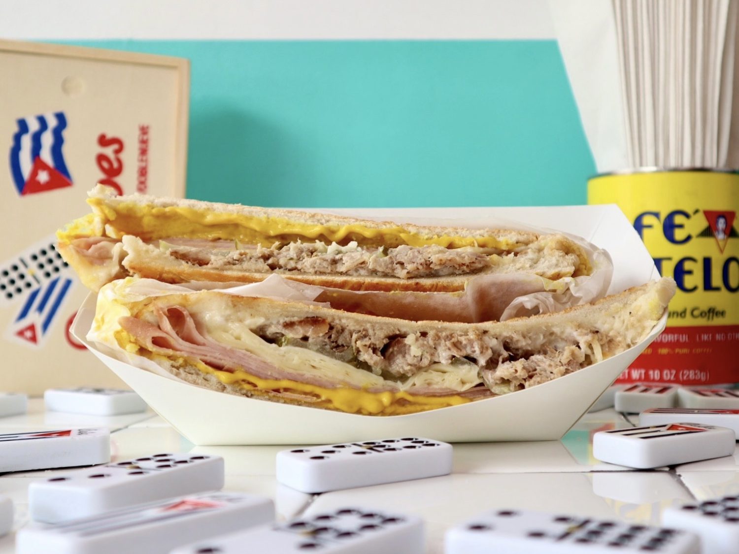a long, thin sandwich filled with meat in a container