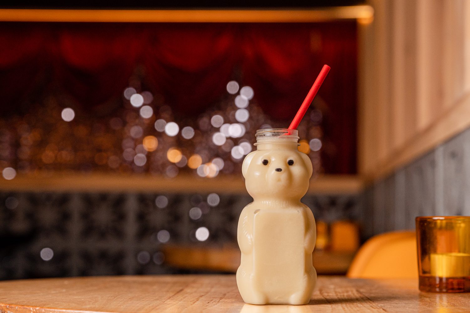 a cup shaped like a bear cub filled with a cocktail.