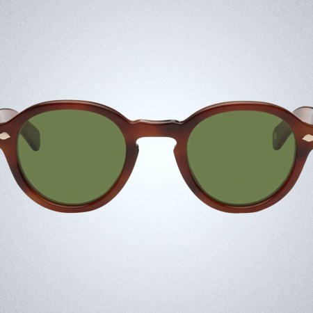 a pair of green lensed tortoiseshell Garett Leight Sunglasses on a grey background