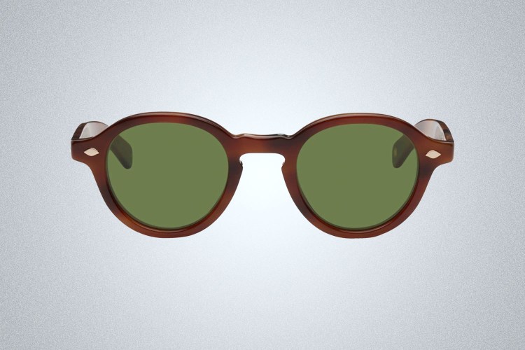 a pair of green lensed tortoiseshell Garett Leight Sunglasses on a grey background