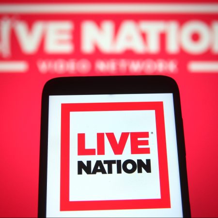 A Live Nation Entertainment logo is seen on a smartphone and a pc screen