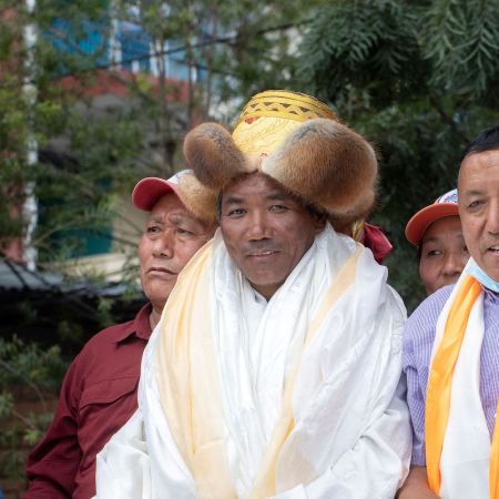 Nepali mountaineer Kami Rita Sherpa (C), who broke his own world record for the most summits after climbing Mount Everest for the 26th time, is welcomed after arriving at Tribhuvan airport in Kathmandu on May 27, 2022