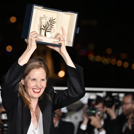 Justine Triet poses with her trophy during a photocall after winning the Palme d'Or during the closing ceremony of the 76th Cannes Film Festival at Palais des Festivals in Cannes, France on May 27, 2023.