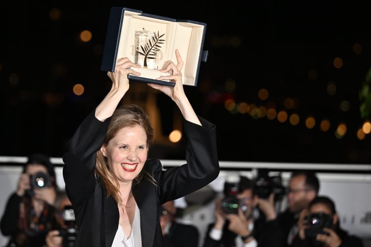 Justine Triet poses with her trophy during a photocall after winning the Palme d'Or during the closing ceremony of the 76th Cannes Film Festival at Palais des Festivals in Cannes, France on May 27, 2023.