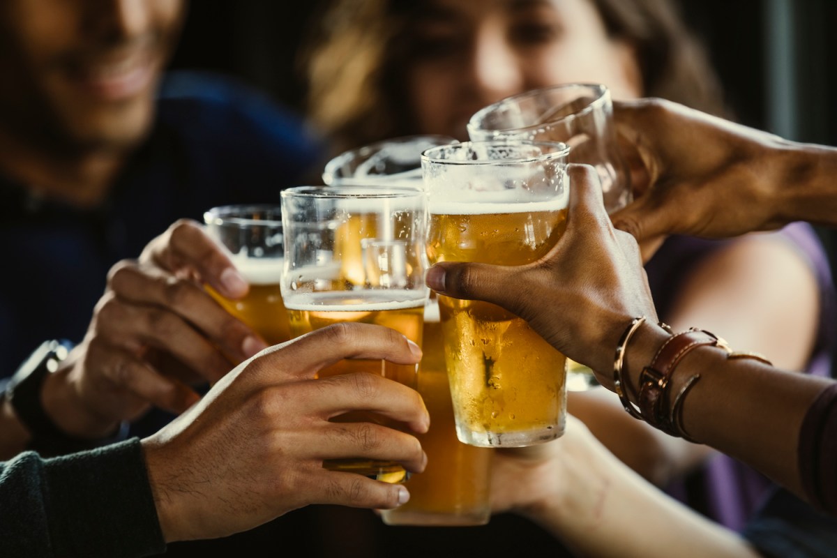 Group of friends toasting beer glasses