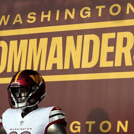 washington commanders football team logo behind mannequin in NFL football uniform