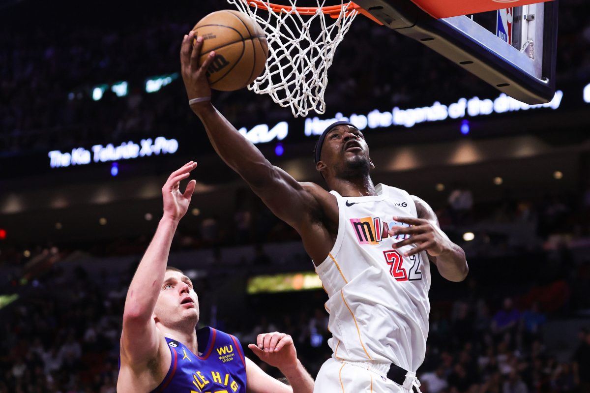 Jimmy Butler of the Heat shoots over Nikola Jokic of the Nuggets in 2023.