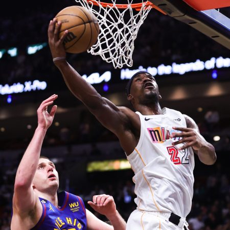 Jimmy Butler of the Heat shoots over Nikola Jokic of the Nuggets in 2023.