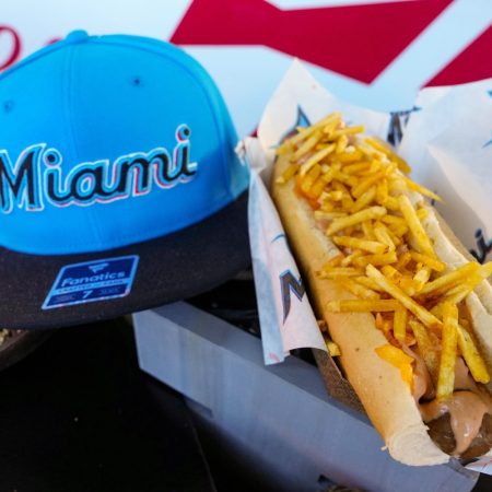 loaded hot dog next to miami marlins hat