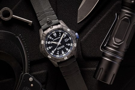 a photo of a Protek USMC watch on a black background