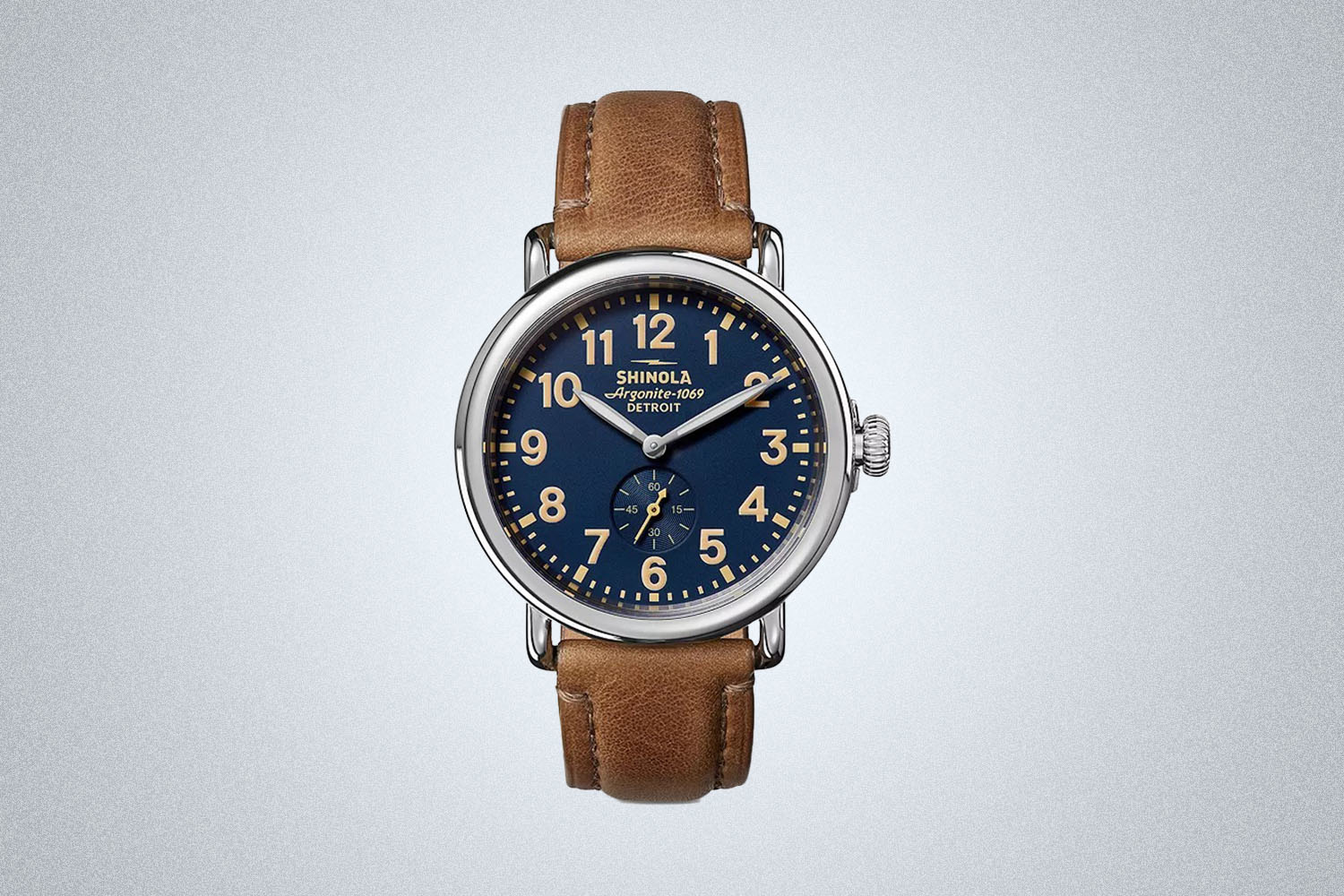 a brown leather Shinola 41mm Runwell Watch on a grey background