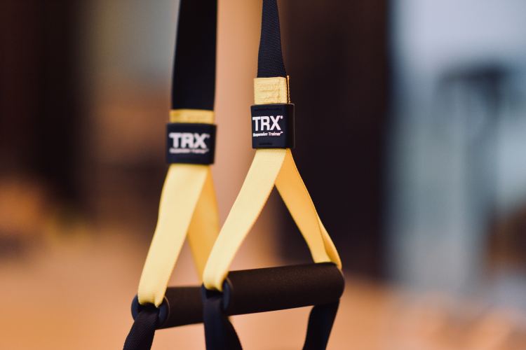 A TRX system dangling across the frame.