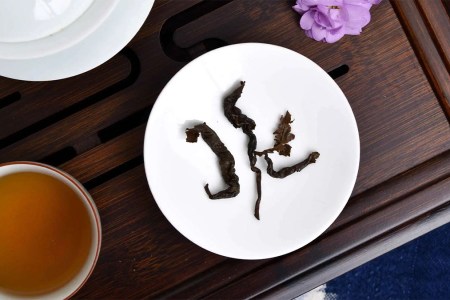 Verdant Tea leaves laying on a white porcelain plate