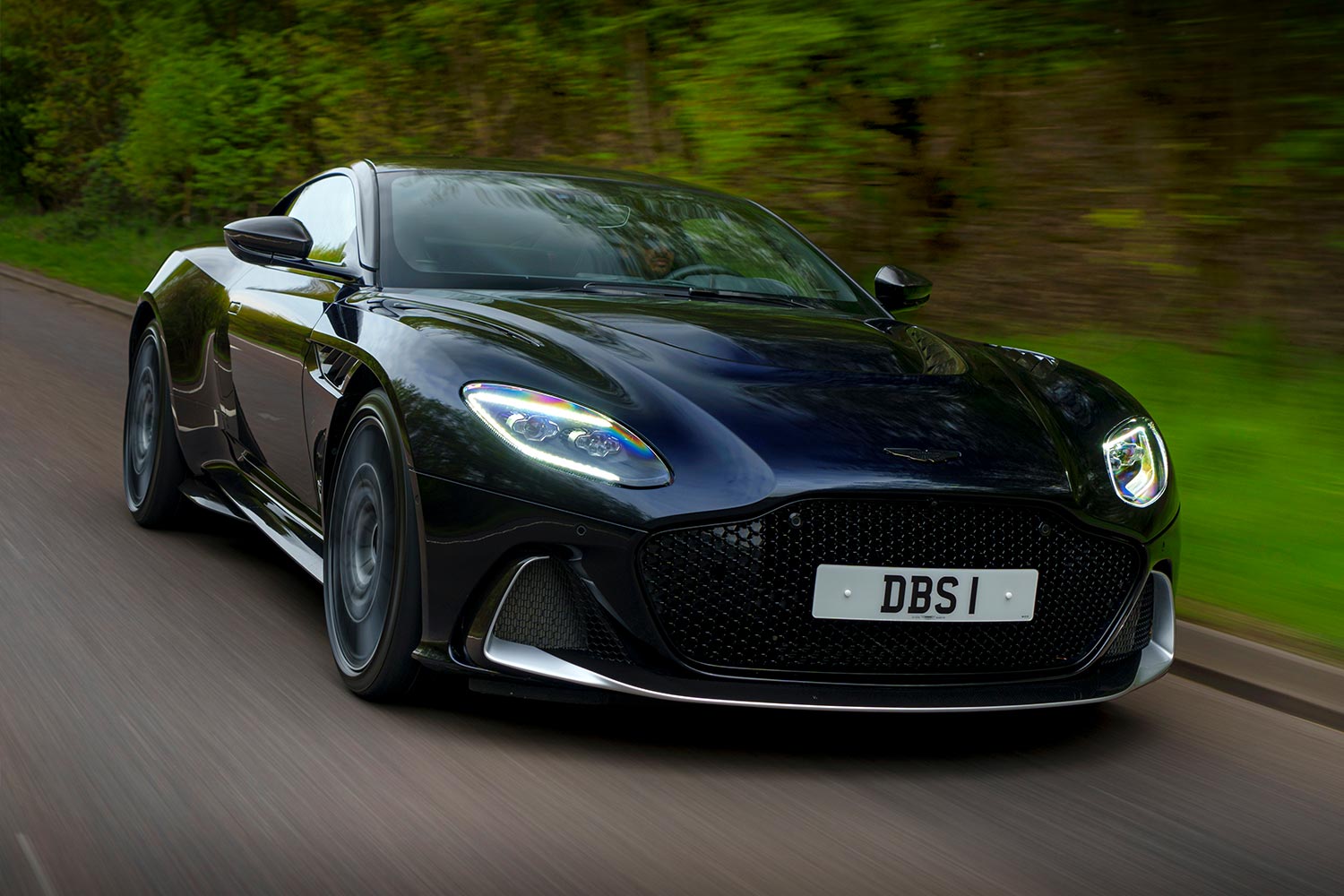 The Aston Martin DBS 770 Ultimate Coupe speeding down the road