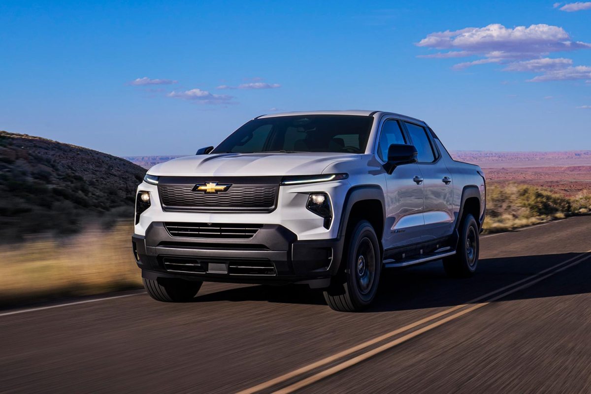 Chevrolet Silverado EV Work Truck driving in the country. The Chevy EV WT is estimated to have a top range of 450 miles.