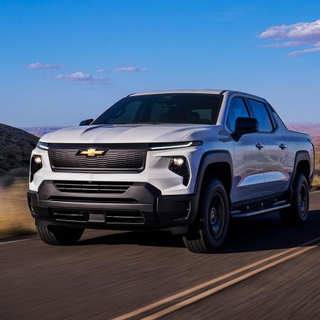 Chevrolet Silverado EV Work Truck driving in the country. The Chevy EV WT is estimated to have a top range of 450 miles.