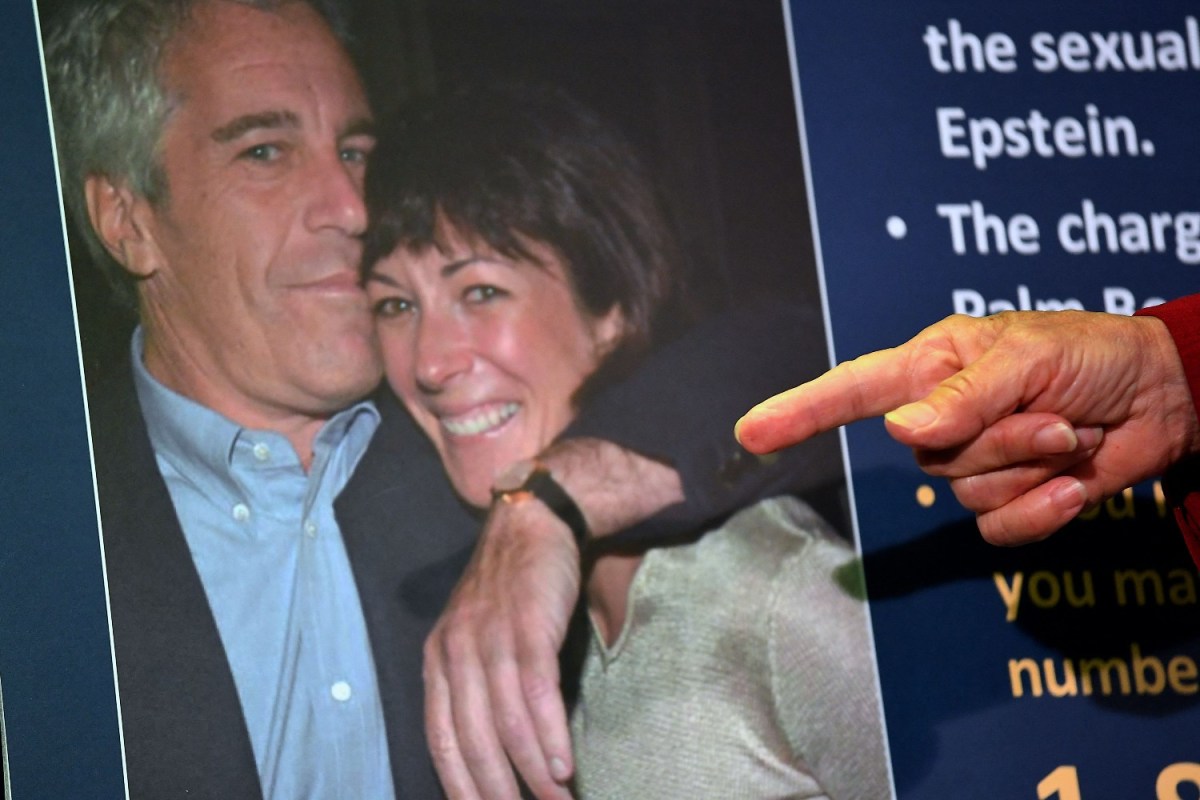 Finger pointing at a photo of Jeffrey Epstein