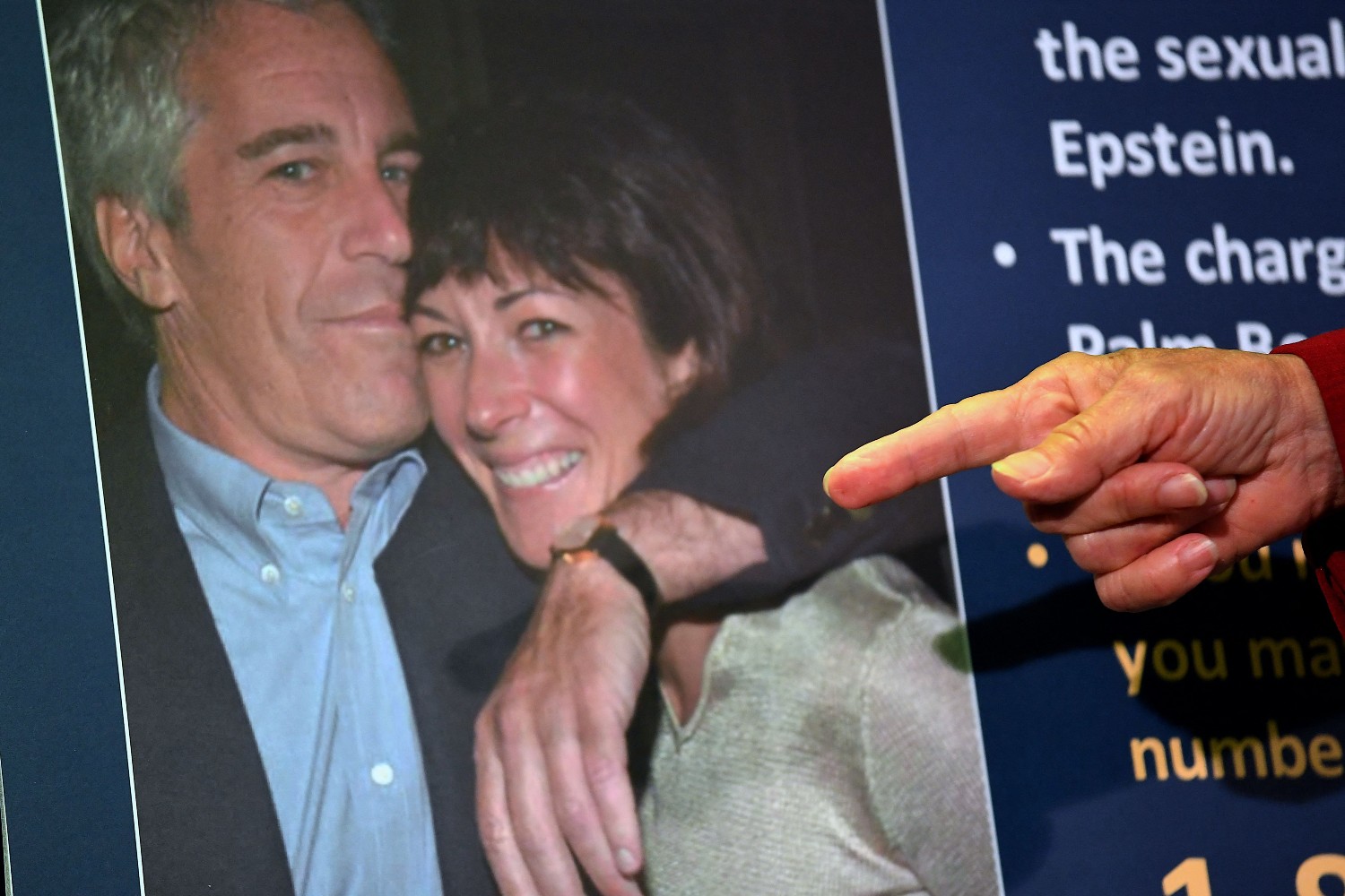 Finger pointing at a photo of Jeffrey Epstein