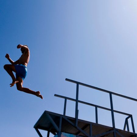 A man jumps off a diving board.