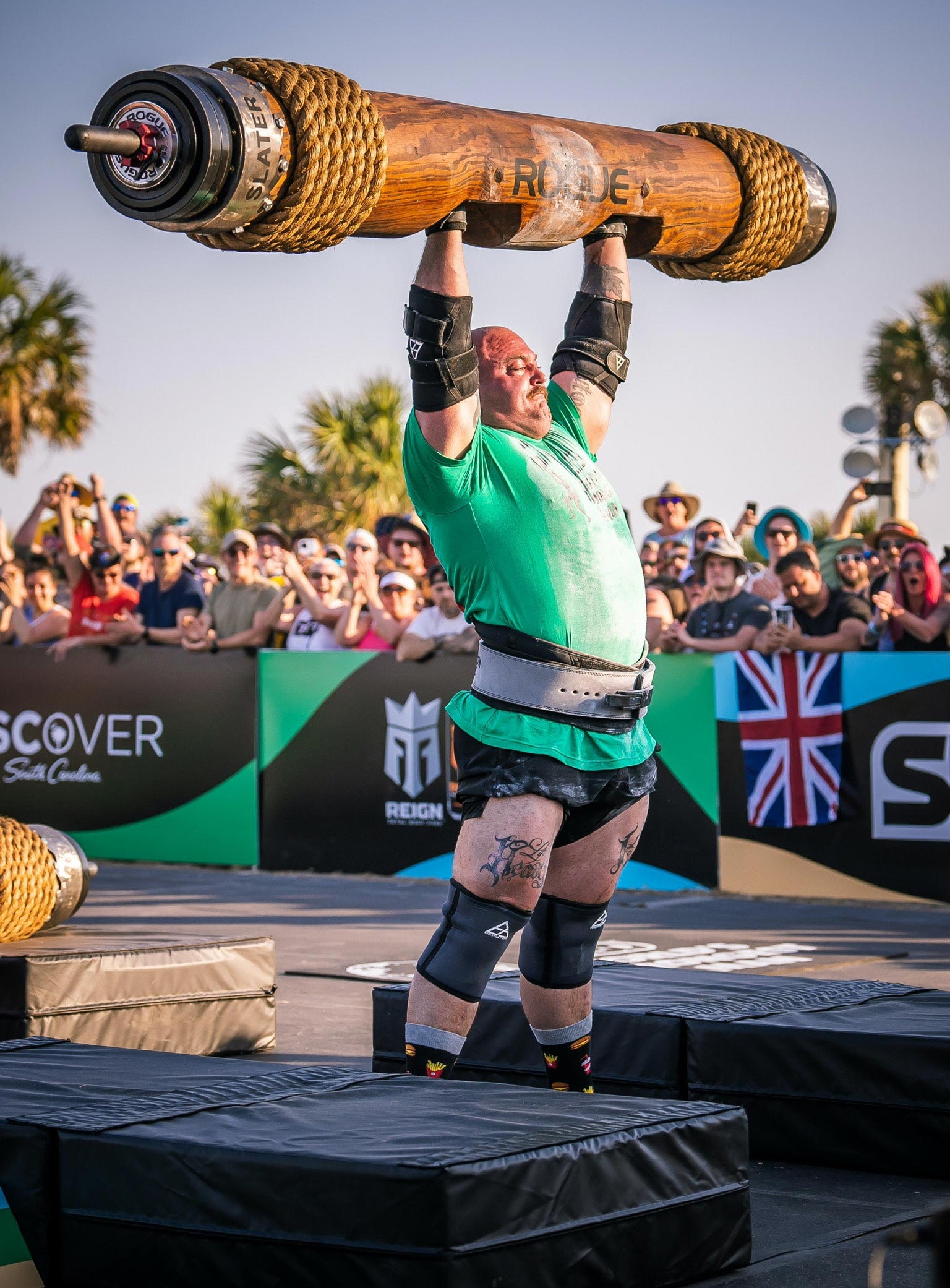 Strongman Mitchell Hooper lifting a log over his head at World's Strongest Man 2023