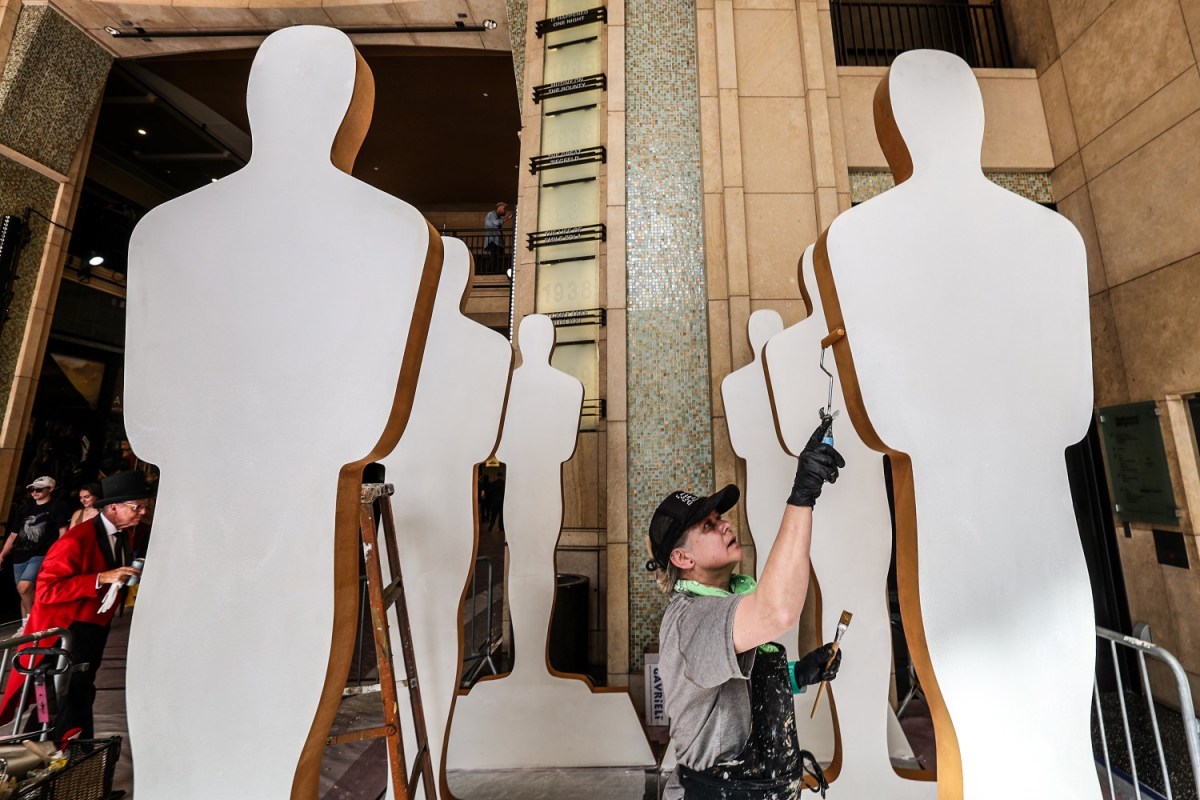 Saule Pictys touches up Oscar cutouts as crews continue to build the red carpet at the 94th Academy Awards at the Dolby Theater.