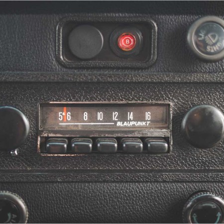 an old car radio dial. AM radio is being removed from several new car models.