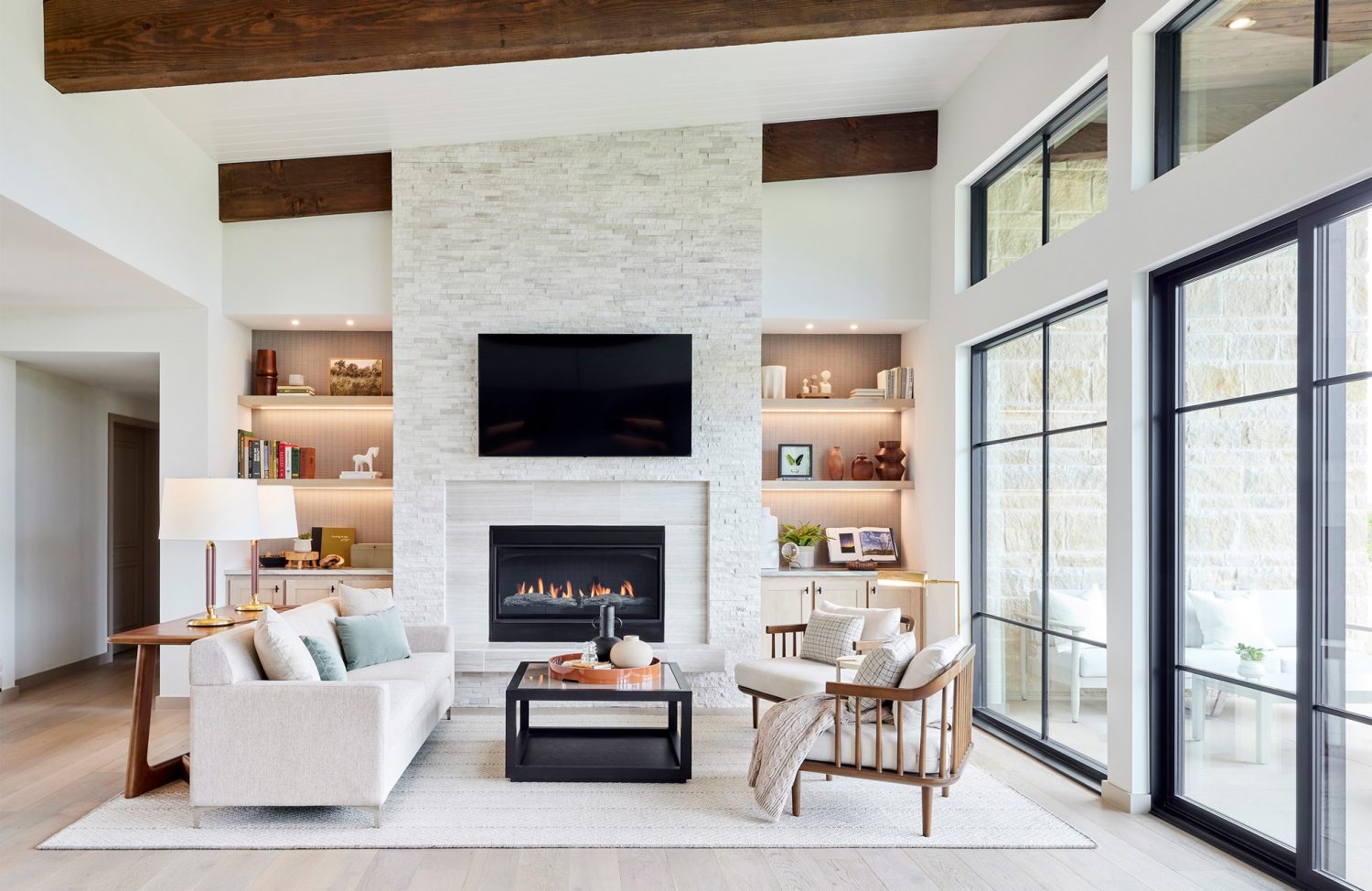 living room with white furniture and floor to ceiling windows