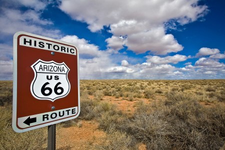 Route 66 sign in front of desert and blue sky