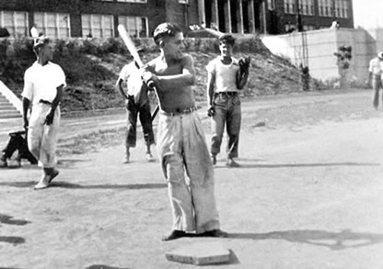 Yogi Berra as a young boy batting right handed with fellow future Big League ballplayer Joe Garagiola behind him with a glove