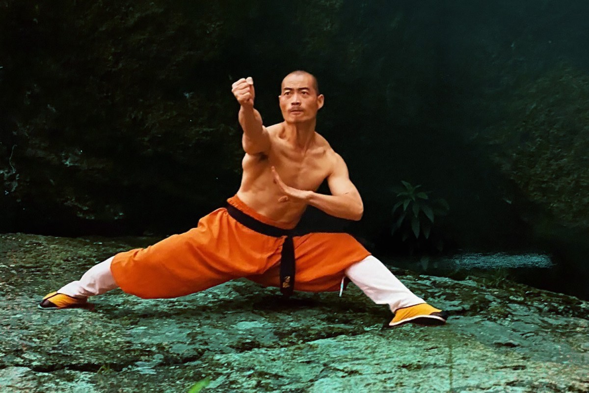 A Shaolin warrior monk clenching his fist towards the camera.