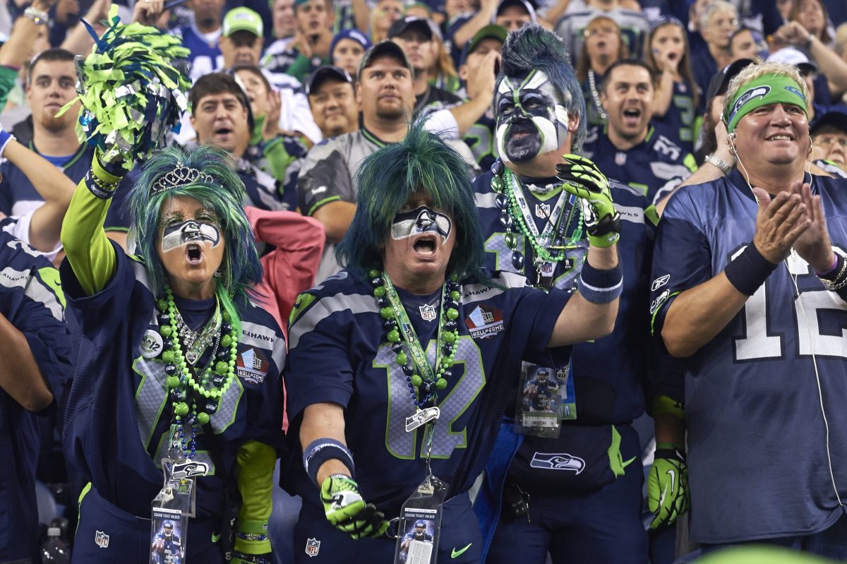 Seattle Seahawks fans with faces painted during a game.