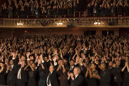 A crowd of people giving a standing ovation