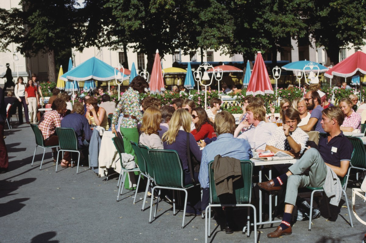 A group of Germans drinking beers at a cafe outside.